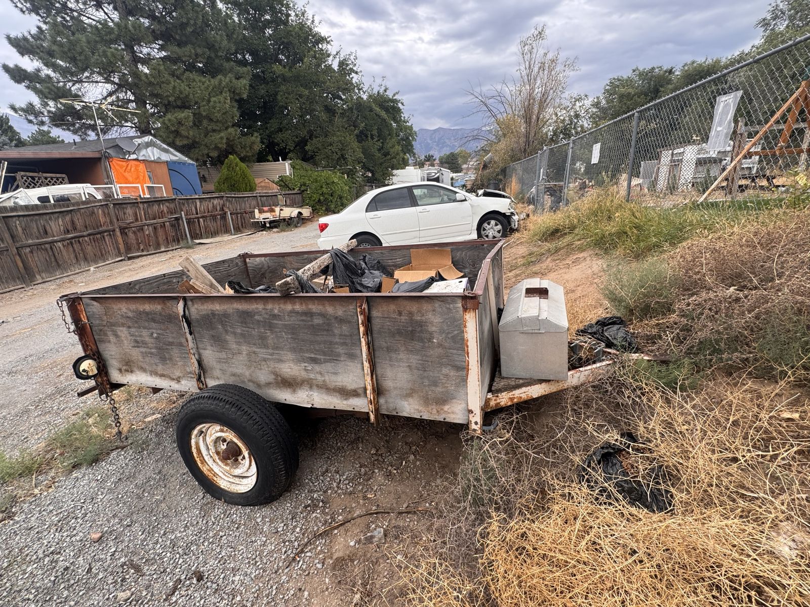 Single-Axle Utility Trailer with Wooden Side Walls and Tool Box