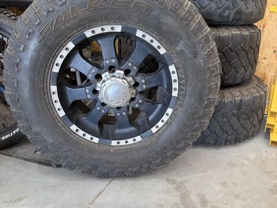 Falken Wildpeak 35x12.50R18LT All-Terrain Tires w/ Black & Silver Wheels (4)