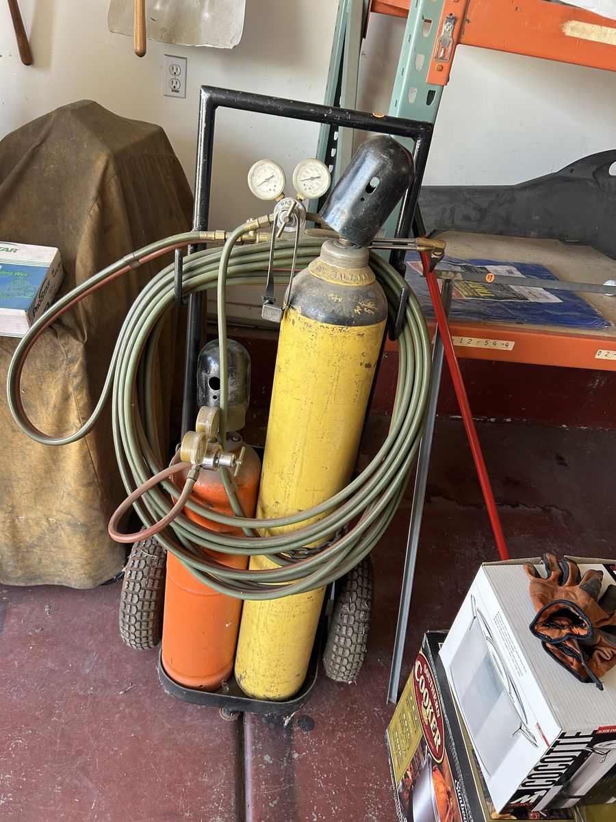 Oxy-Acetylene Torch Setup with Tanks, Regulators, Hose, Torch, and Wheeled Cart