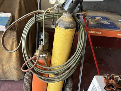 Oxy-Acetylene Torch Setup with Tanks, Regulators, Hose, Torch, and Wheeled Cart