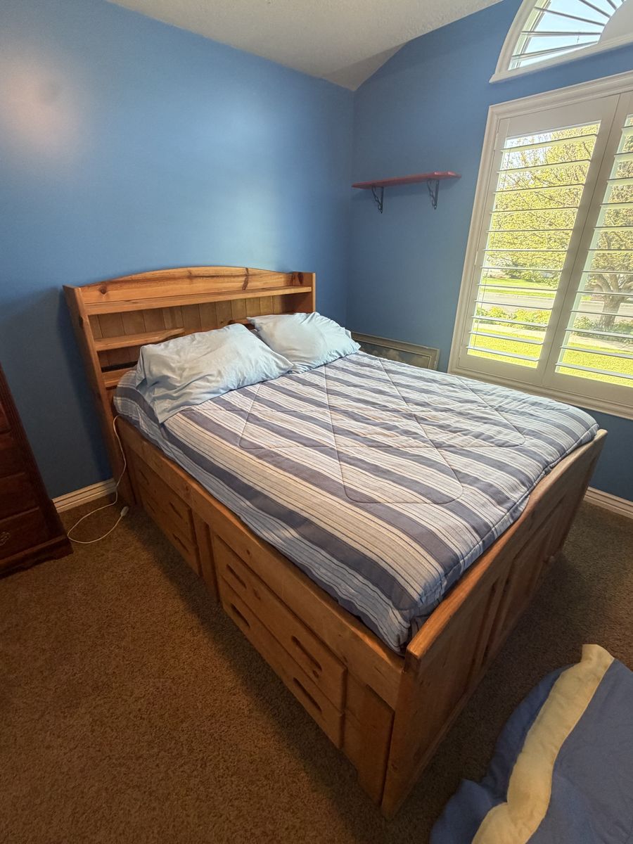 Full size pedestal bed with drawers and mattress.