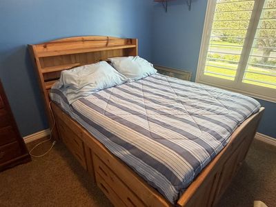 Full size pedestal bed with drawers and mattress.
