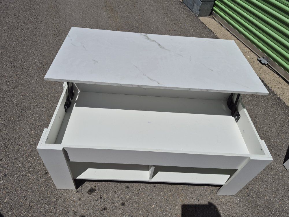 white lift-top coffee table with lower storage  shelving