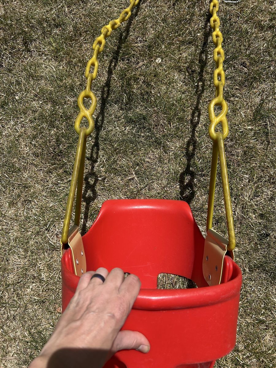 Child’s bucket swing with back rest