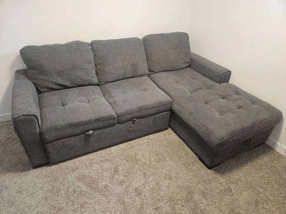 Gray Upholstered Sectional Sofa with Pull-Out and Storage section