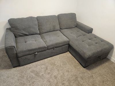 Gray Upholstered Sectional Sofa with Pull-Out and Storage section