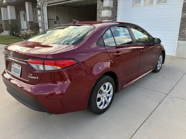 2023 Toyota Corolla Hybrid LE — rebuilt & branded title, 10% below market