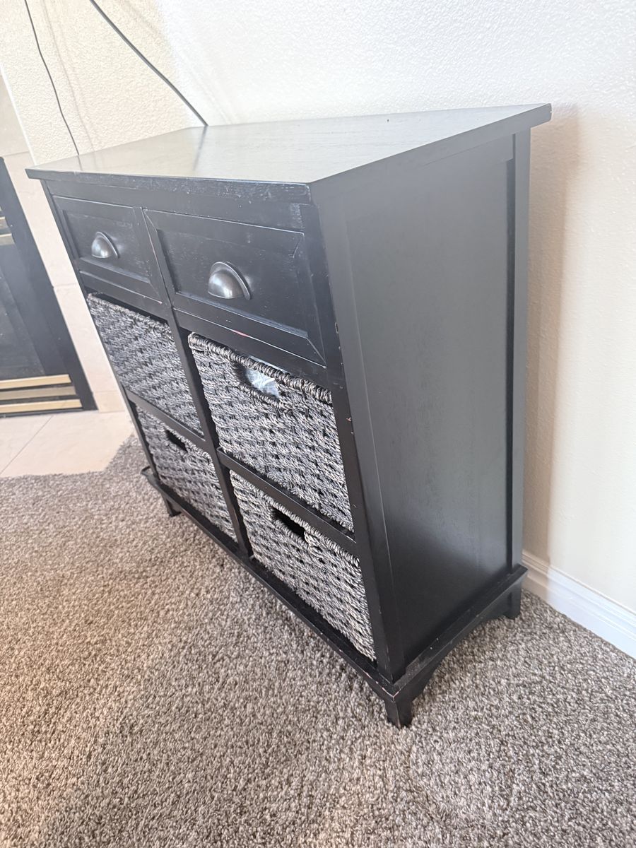 Black cabinet with 2 drawers and 4 baskets for storage