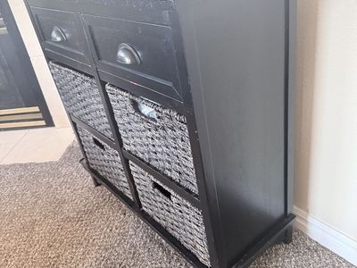Black cabinet with 2 drawers and 4 baskets for storage