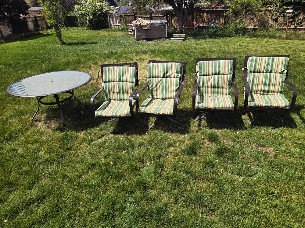 outdoor table and 4 swivel chairs