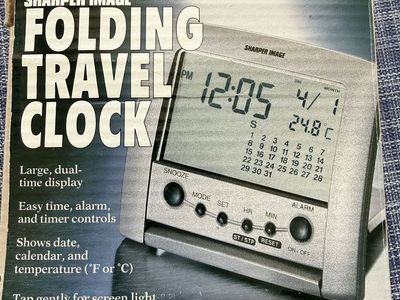 This is a Sharper Image Folding Travel Clock with a digital display and temperature tracker.