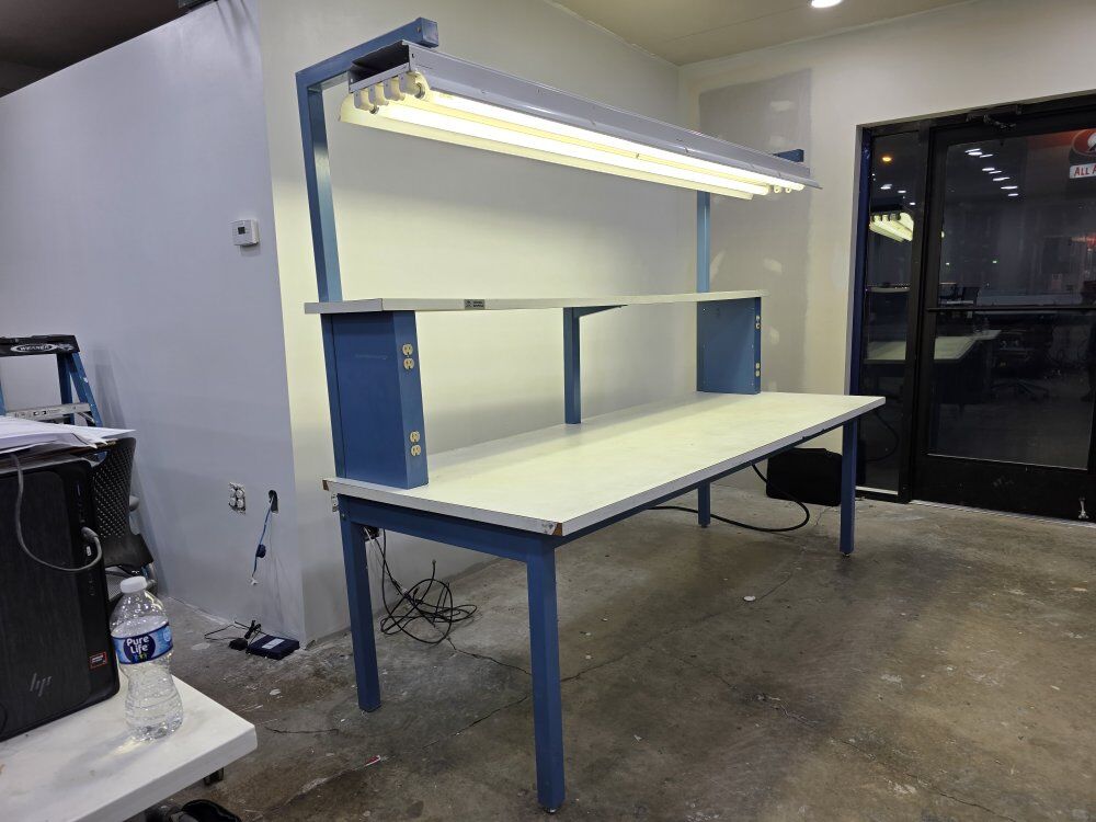 Table with lighting, levels and power strips