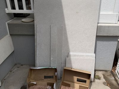 Brick backer board scraps, thin brick tiles and cutter