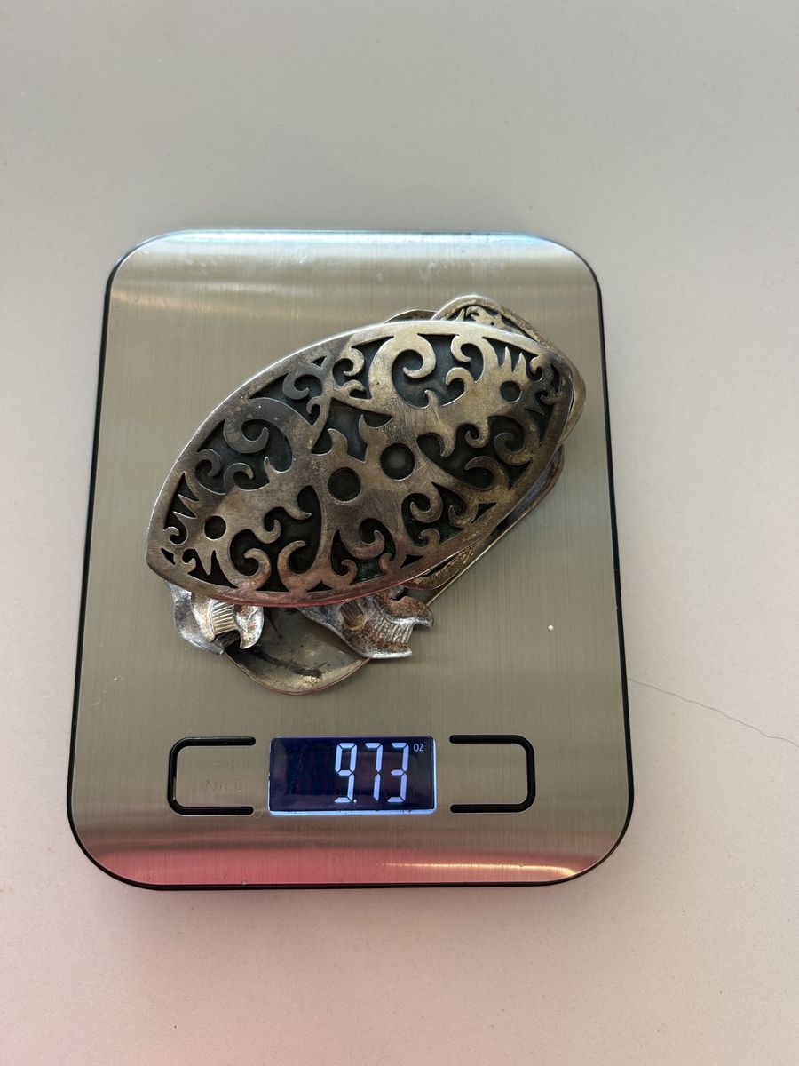 9.73 oz of silver in the form of belt buckles and pins