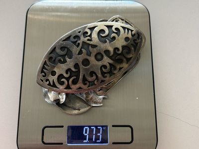 9.73 oz of silver in the form of belt buckles and pins