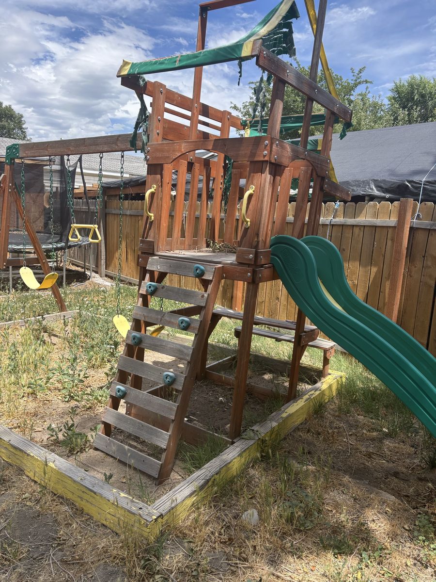 Used Wooden Backyard Playset with Swings, Slide, and Climbing Wall - Great for Kids Outdoor Fun