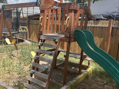 Used Wooden Backyard Playset with Swings, Slide, and Climbing Wall - Great for Kids Outdoor Fun