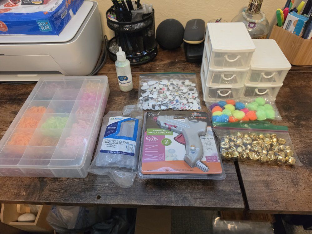 Assorted Crafting Supplies: Loom Bands, Googly Eyes, Mini Hot Glue Gun, Bells, Pompoms, Liquid Chalk, and much more.