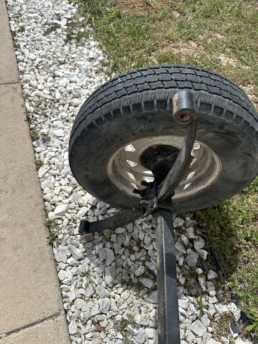 Trailer axel with springs and wheels