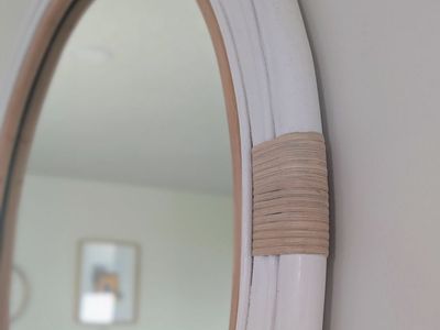 30 inch wall mirror. Beautiful, nautical themed with Rattan frame.
