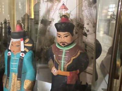 vintage Mongolian or Chinese clay figurines, often depicting an Emperor and Empress in traditional regalia