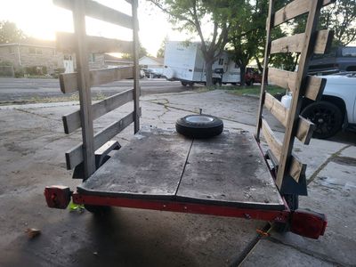 Utility Trailer with Wooden Side Racks and Red Metal Frame