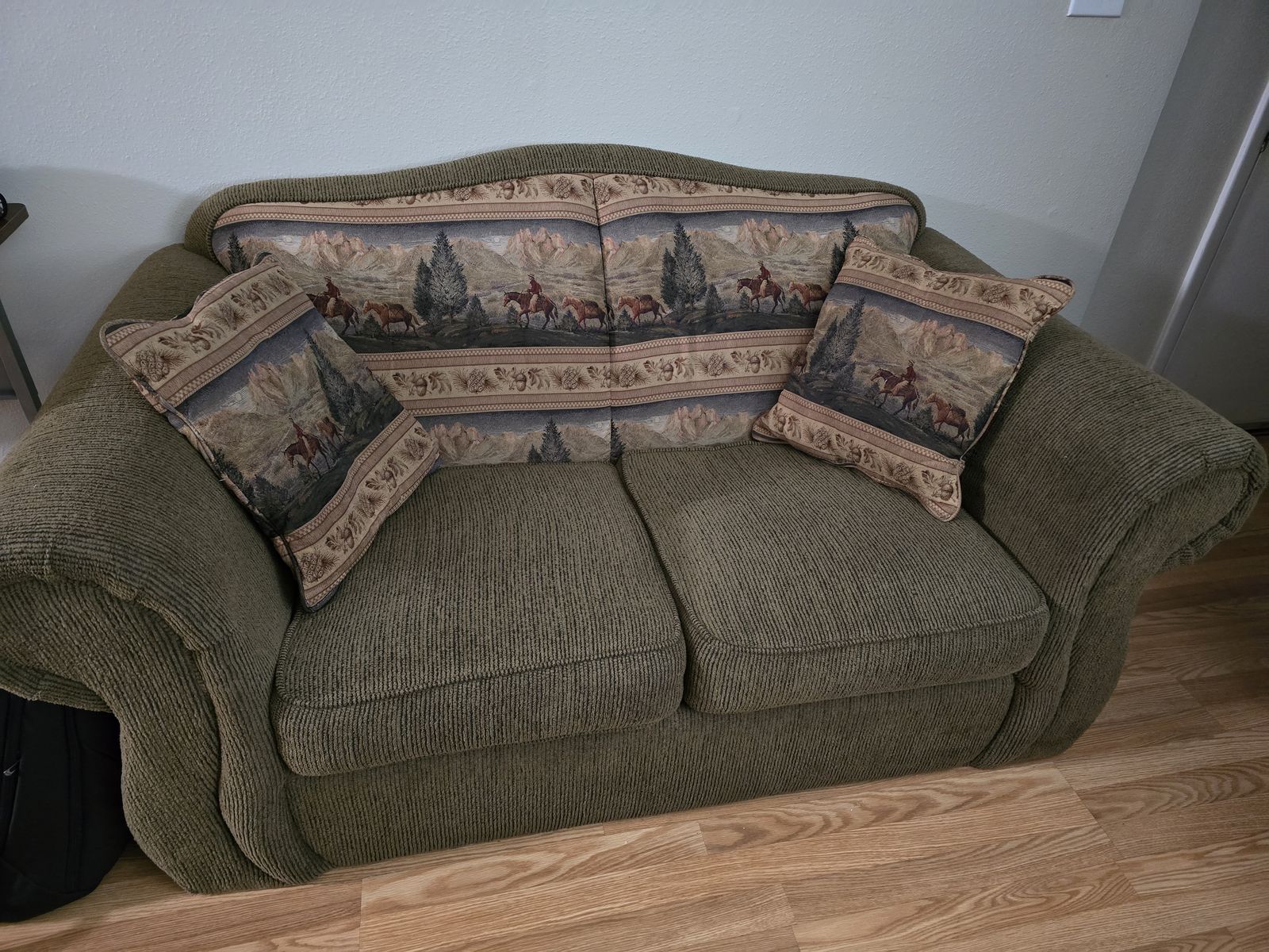 2 seater couch with country design cushions and backdrop
