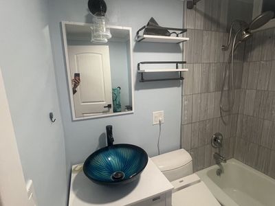 Bathroom vanity, sink, faucet, mirror, light and shelves