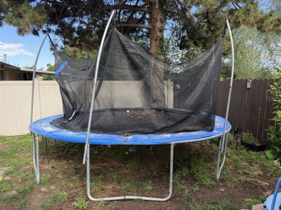 Used Outdoor Trampoline with Safety Net - Blue Pad and net Needs Minor Repair