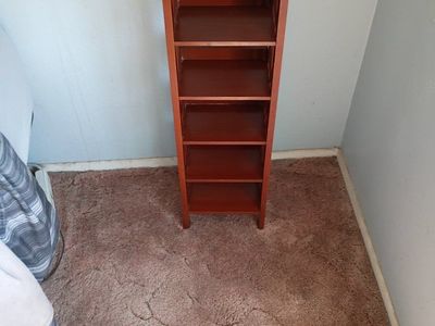 Tall Wooden Storage Tower with Multiple Shelves