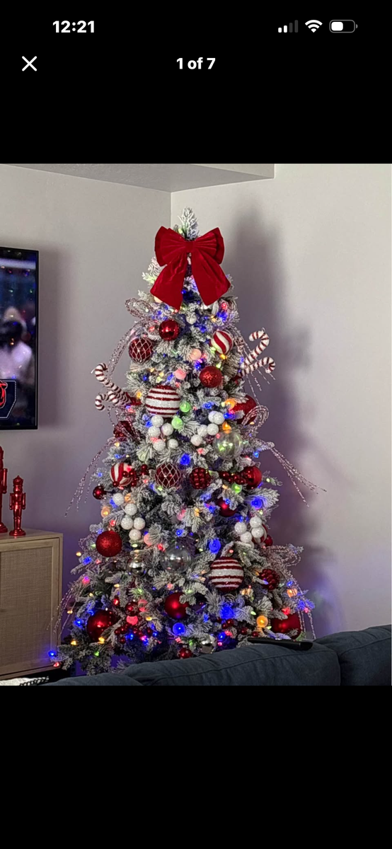 7 1/2 foot pre-lit flocked Christmas tree with white and multicolored light.