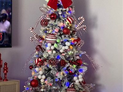 7 1/2 foot pre-lit flocked Christmas tree with white and multicolored light.