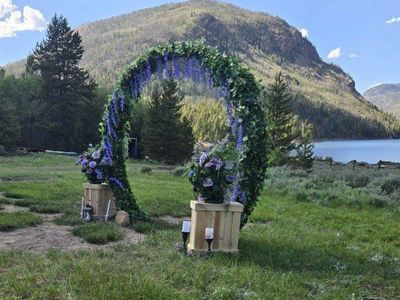 Wedding Archway Decorated with 2 Wooden Plant Stands & Bouquets