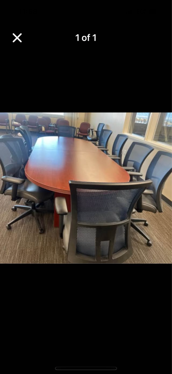 Conference table cherry 48x120 with 8 chairs sit on it amplify