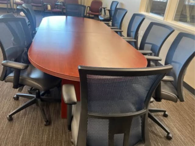 Conference table cherry 48x120 with 8 chairs sit on it amplify