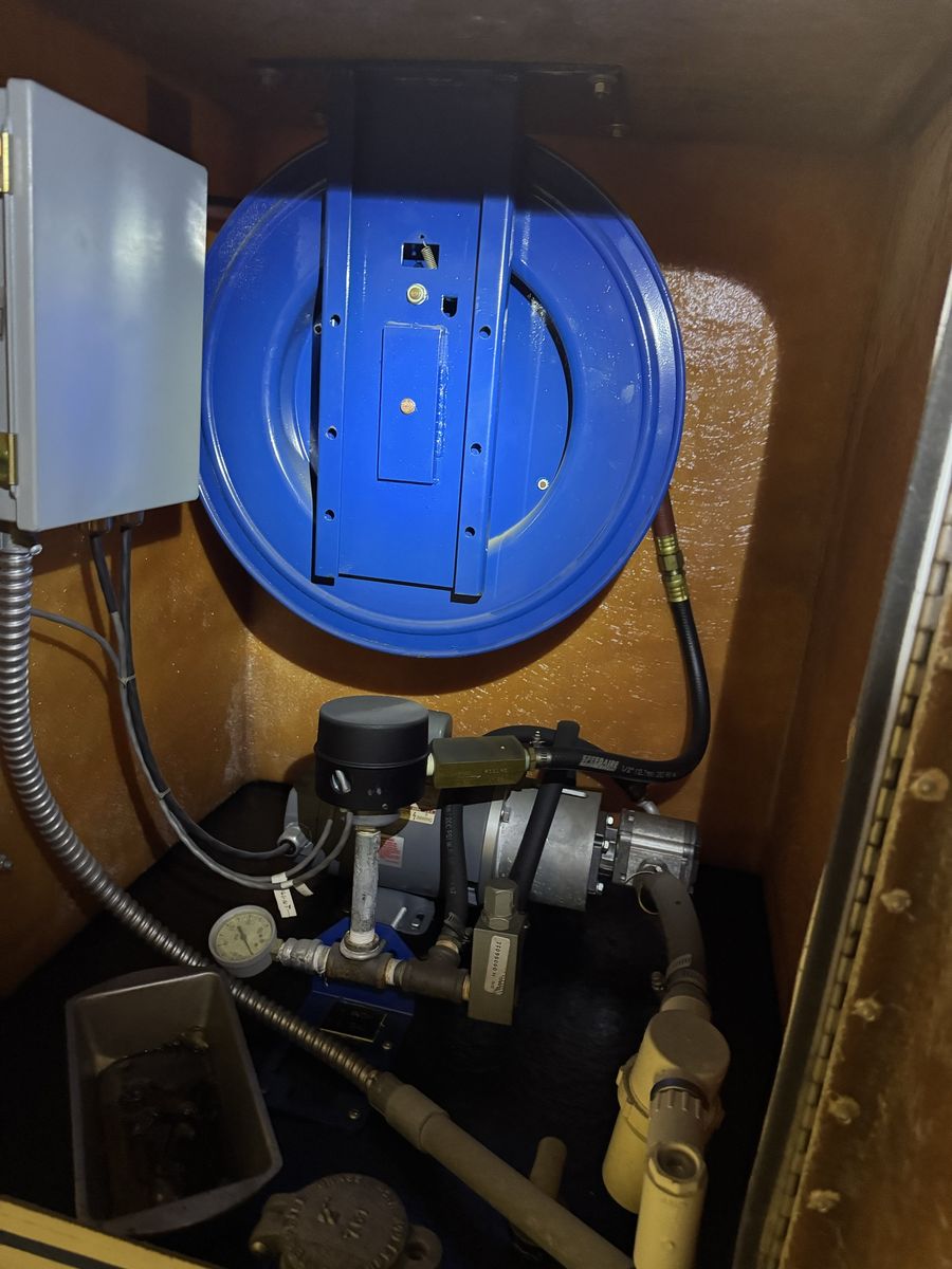 Oil tank with pump and reel.