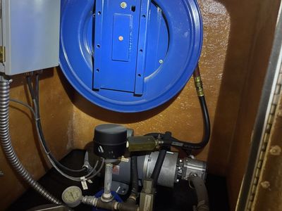 Oil tank with pump and reel.