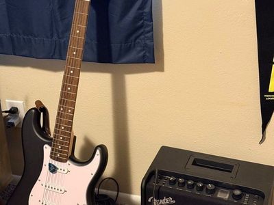Squire guitar and Fender Mustang LT25 amplifier
