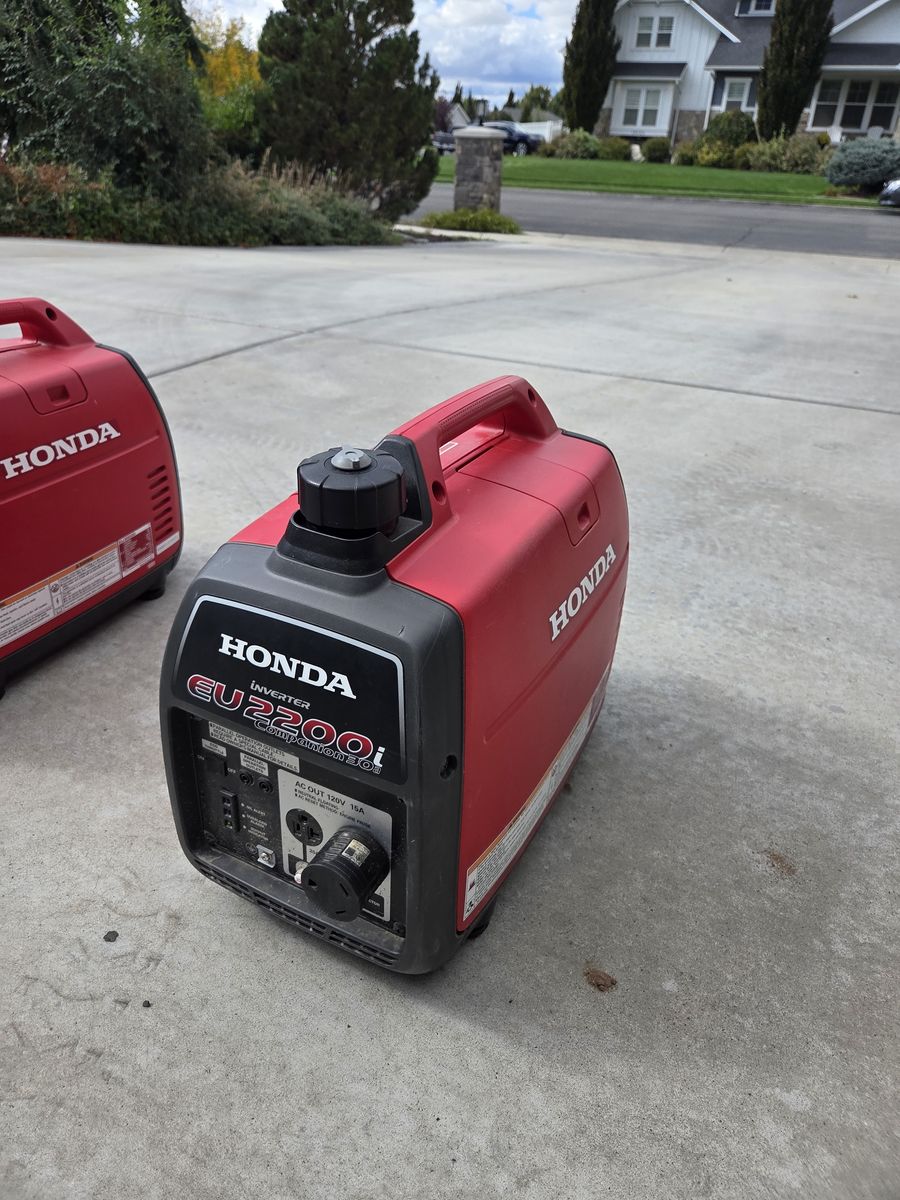 Pair of Honda EU 2200i Generators with parallel cords and covers