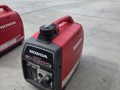 Pair of Honda EU 2200i Generators with parallel cords and covers