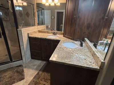 Primary Bathroom Corner Alder Cabinets.