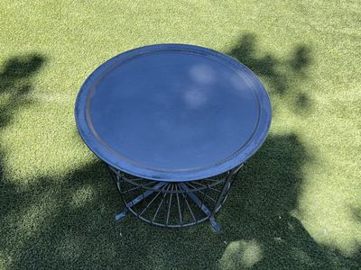 Round metal side/coffee table with storage .