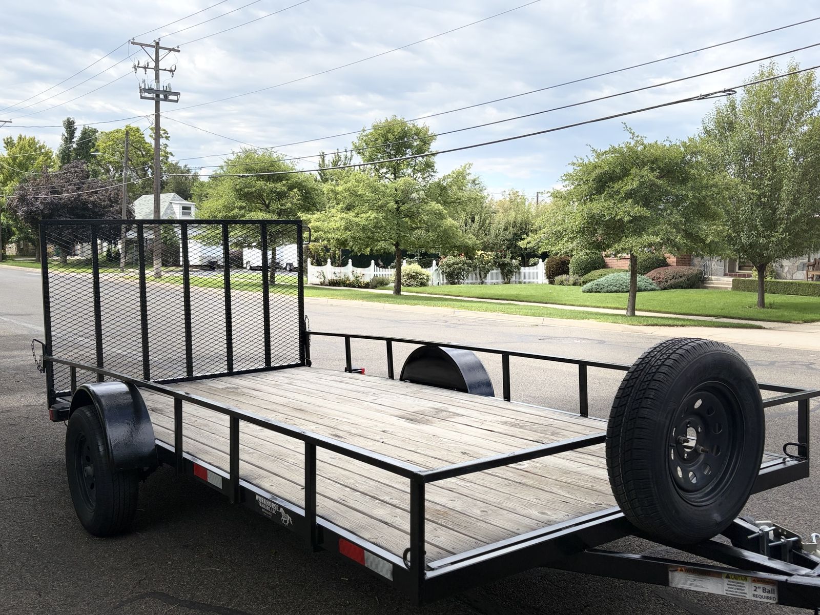 2020 Workhorse 7x14 flatbed trailer extra tie down spots, ramp, and spare tire.