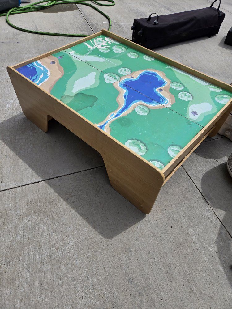 Kids play table with under-side storage on both ends.