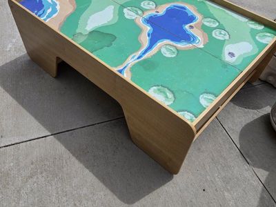 Kids play table with under-side storage on both ends.