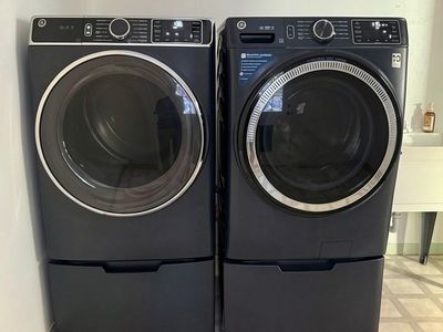 GE 4.8 cu. ft. Front Load Washer & Dryer Set with Pedestals - navy blue