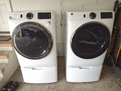 GE Washer and Dry set with Pedestals. Only used for 6 months. Electric