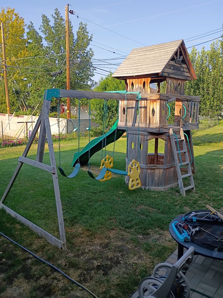 Outdoor Wooden Swing Set with Wave Slide, Two Swings, Two-Person Glider, and Playhouse Fort