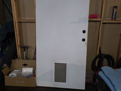 Metal exterior door with doggie door in it