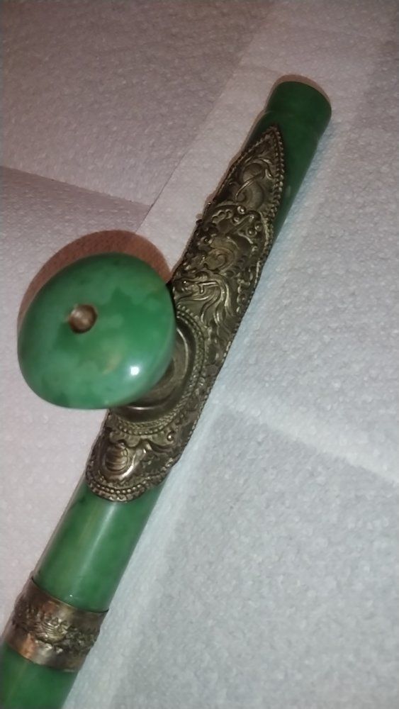 The pipe is constructed from two pieces of apple-green jade, all with a smooth polish. The opaque jade is of a striking apple gr